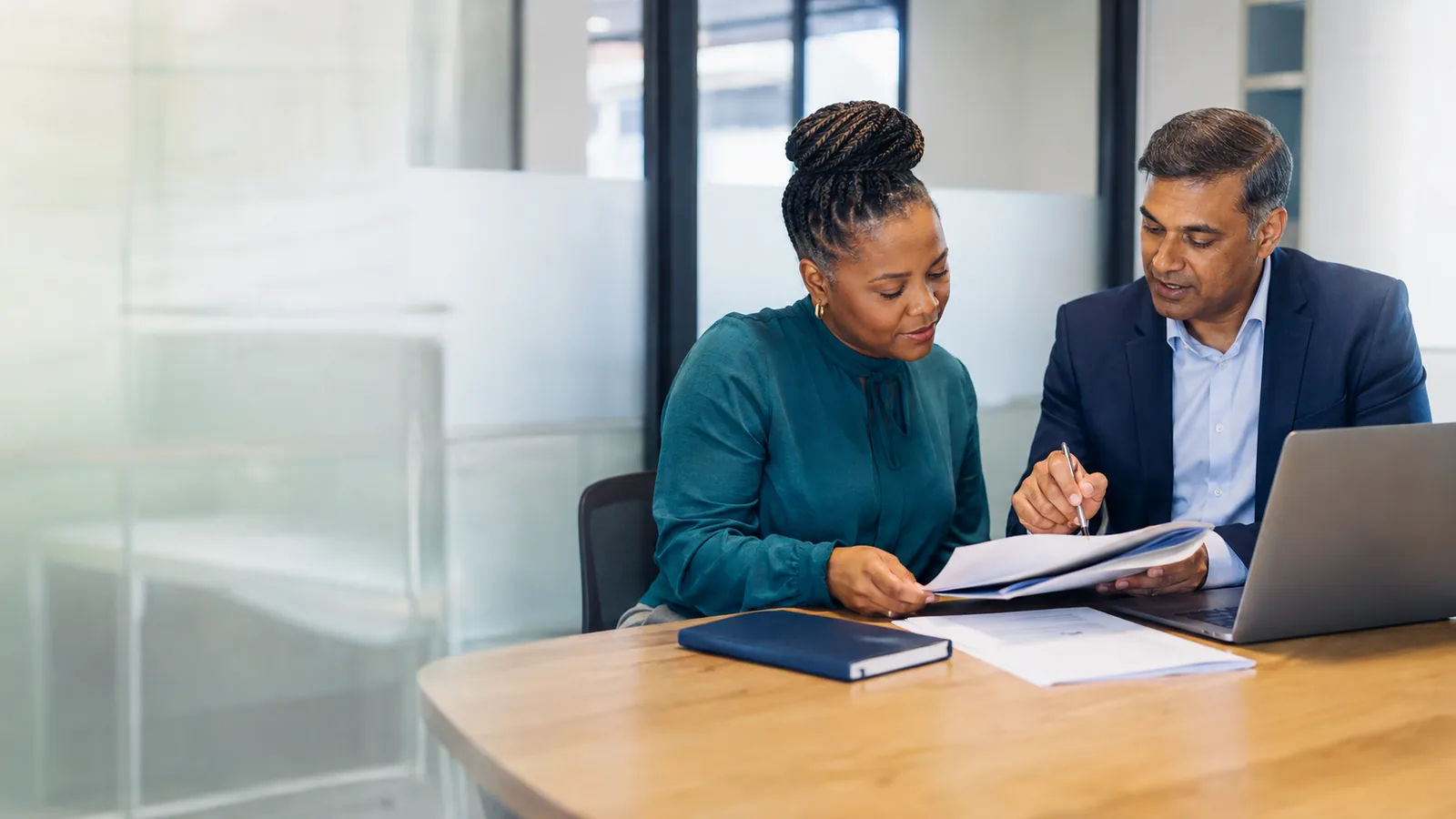 A consultant and a business owner going through an organised compliance file together